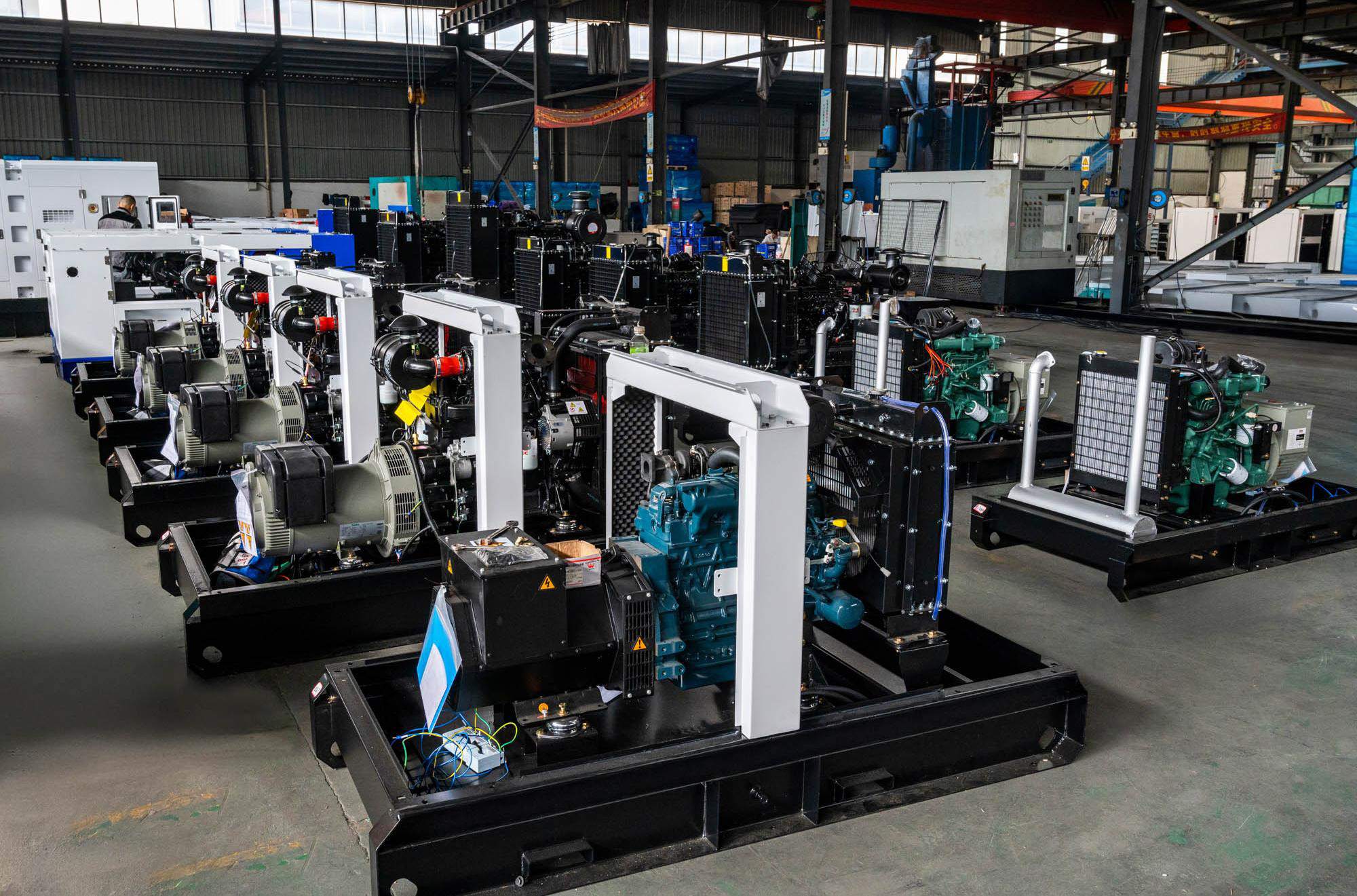 Semi-assembled diesel generator units on the factory floor, showing the engine, alternator, and base frame structure during the middle stages of manufacturing.