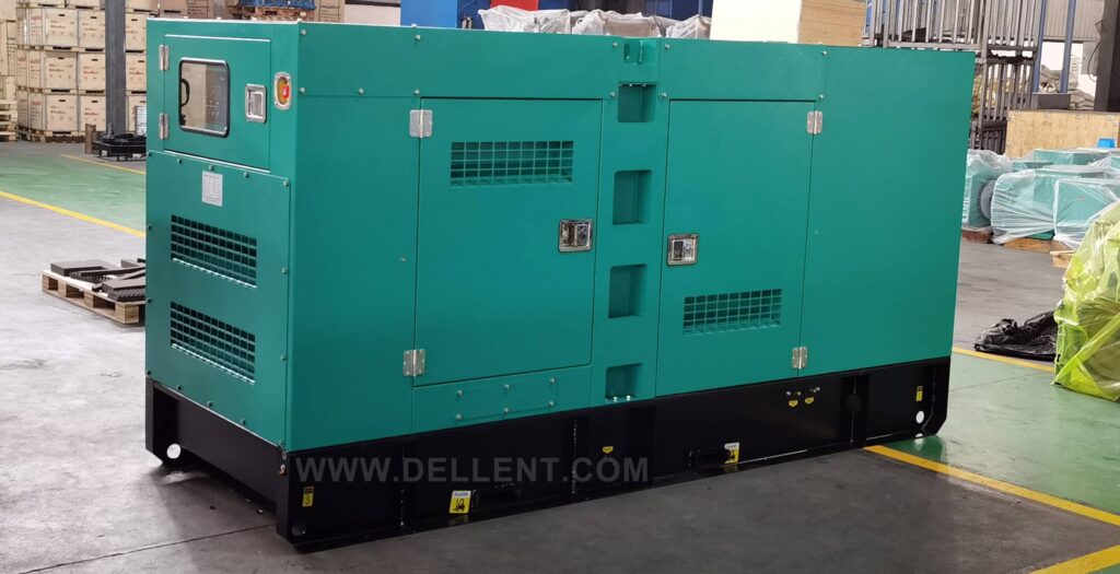 A large green silent diesel generator set with a soundproof canopy enclosure and a black base frame, pictured inside a manufacturing factory.